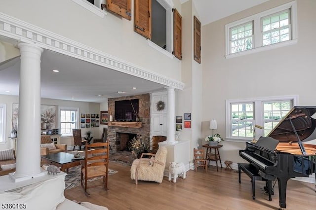 760 Rosemont Ringoes Rd, Delaware Twp, NJ 08559 - living room featuring ornate columns, wood finished floors, a fireplace, and a towering ceiling