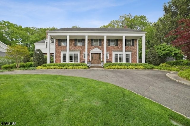 70 Falmouth St, Millburn Twp, NJ 07078 - neoclassical home with a front yard, brick siding, and covered porch