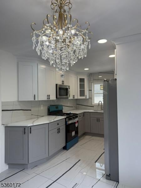 20 Wick Dr, Woodbridge Twp, NJ 08863 - kitchen with appliances with stainless steel finishes, a sink, gray cabinets, and a chandelier