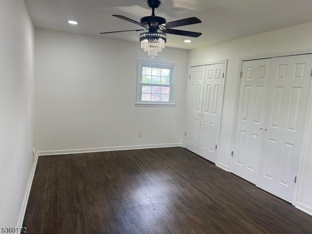 20 Wick Dr, Woodbridge Twp, NJ 08863 - unfurnished bedroom with multiple closets, baseboards, dark wood-type flooring, recessed lighting, and ceiling fan