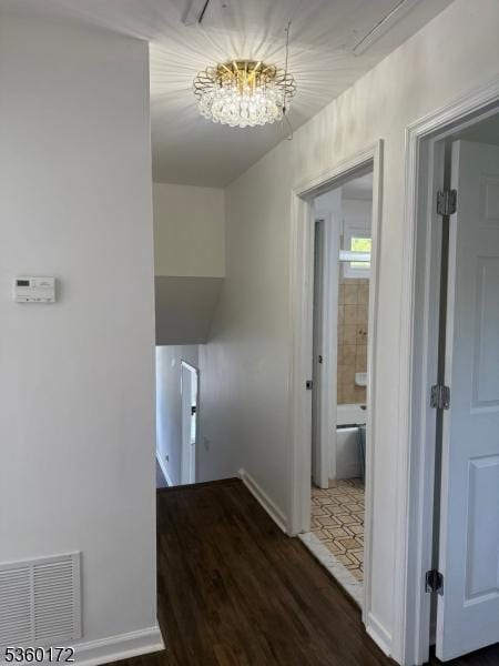 20 Wick Dr, Woodbridge Twp, NJ 08863 - hallway with a chandelier, baseboards, and wood finished floors