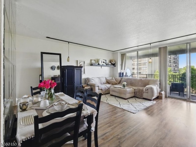 5 Horizon Rd Unit 306, Fort Lee Boro, NJ 07024 - dining room featuring wood finished floors, a textured ceiling, and a wall of windows
