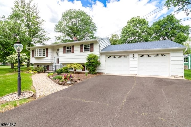 3 Hayward St, Bridgewater Twp, NJ 08805 - view of front facade with asphalt driveway, a garage, a front yard, and a chimney