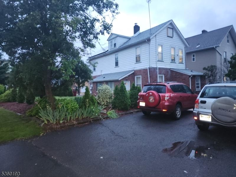 20 Harrison St, Nutley Twp, NJ 07110 - view of property exterior featuring a chimney and brick siding