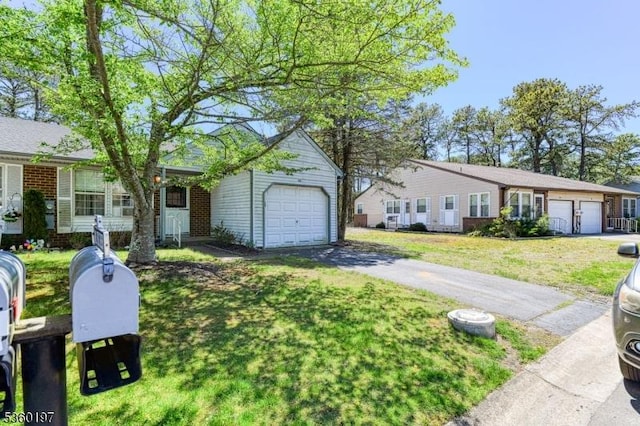 11 B Greenwood Ln Unit Sec62, Manchester Twp, NJ 08759 - ranch-style home with driveway, a front yard, brick siding, and an attached garage