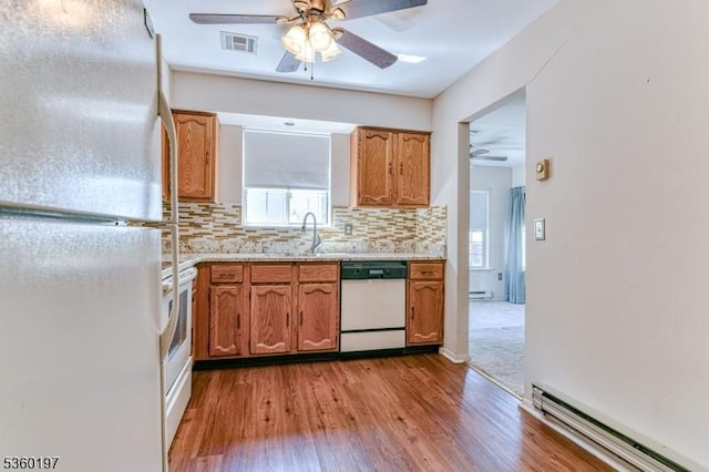11 B Greenwood Ln Unit Sec62, Manchester Twp, NJ 08759 - kitchen with white appliances, a ceiling fan, a baseboard radiator, wood finished floors, and backsplash