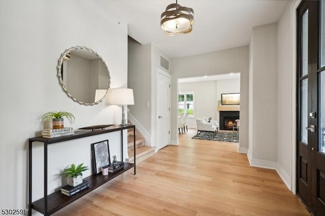 603 Springfield Ave Unit 104, Summit City, NJ 07901 - foyer with light wood-style flooring, baseboards, a lit fireplace, and stairway