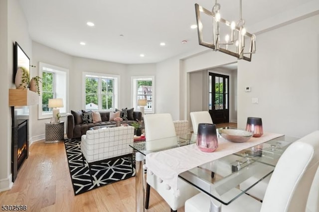 603 Springfield Ave Unit 104, Summit City, NJ 07901 - dining space with light wood finished floors, healthy amount of natural light, a lit fireplace, recessed lighting, and a chandelier