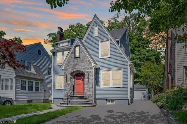 254 Springfield Ave, Rutherford Boro, NJ 07070 - tudor-style house with a chimney, stone siding, and entry steps