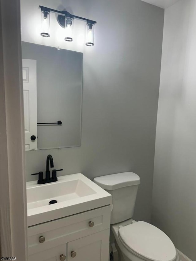 8 Bristol Dr, North Brunswick Twp, NJ 08902 - half bathroom featuring vanity, toilet, and baseboards
