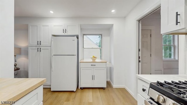 13 Prospect St, Metuchen Boro, NJ 08840 - kitchen with freestanding refrigerator, light wood-style flooring, healthy amount of natural light, white cabinetry, and recessed lighting