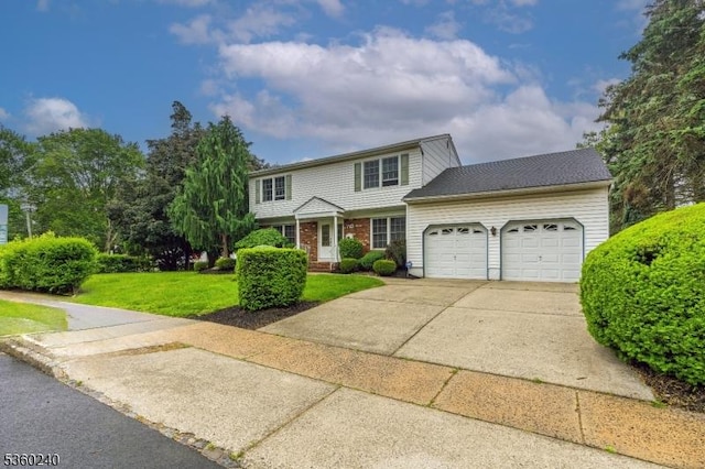 712 Kaminski Dr, Rahway City, NJ 07065 - view of front facade featuring an attached garage, a front lawn, and driveway