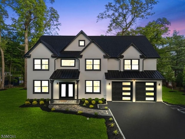 10 Wilson Ave, Wayne Twp, NJ 07470 - view of front of house featuring french doors, stucco siding, a standing seam roof, driveway, and a front lawn