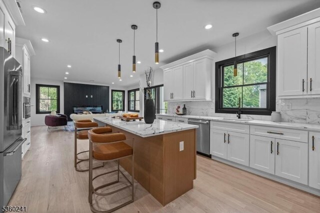 10 Wilson Ave, Wayne Twp, NJ 07470 - kitchen featuring appliances with stainless steel finishes, open floor plan, light wood-type flooring, white cabinetry, and recessed lighting