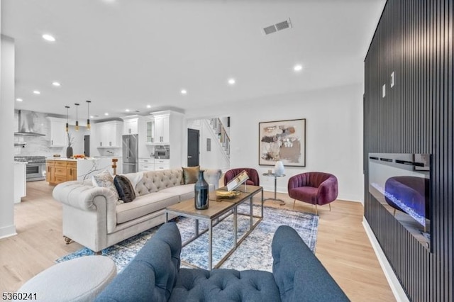 10 Wilson Ave, Wayne Twp, NJ 07470 - living room with light wood-style flooring, recessed lighting, baseboards, and stairs