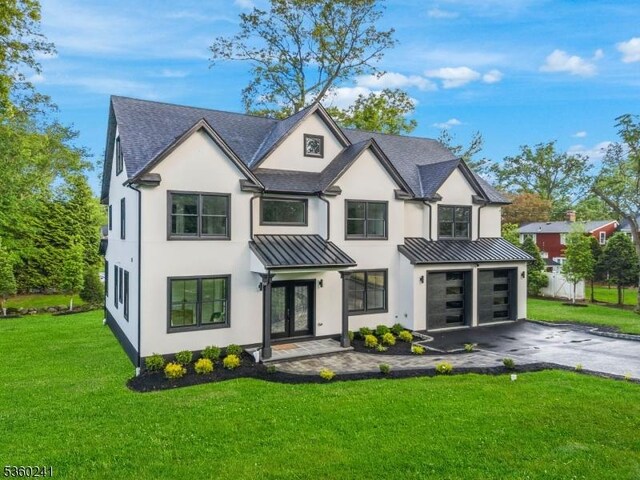 10 Wilson Ave, Wayne Twp, NJ 07470 - view of front facade featuring french doors, a standing seam roof, driveway, and stucco siding