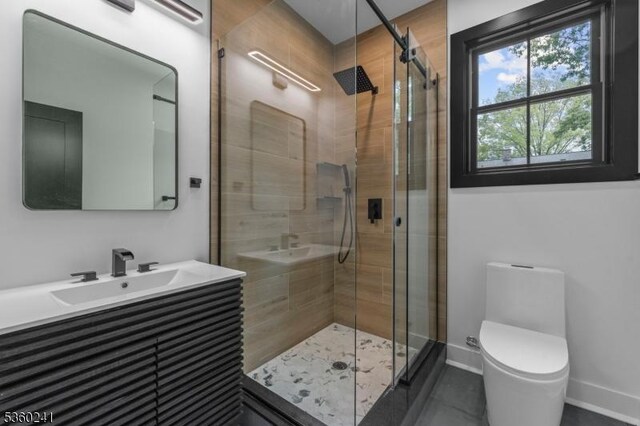 10 Wilson Ave, Wayne Twp, NJ 07470 - full bath featuring vanity, toilet, a shower stall, tile patterned floors, and baseboards