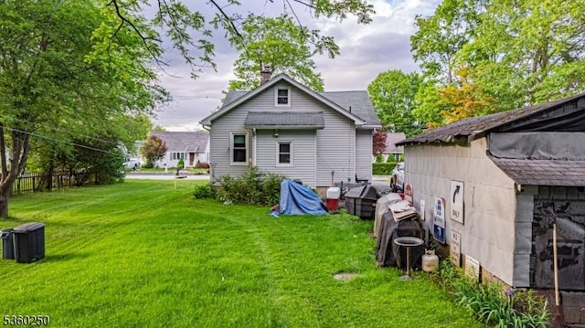 52 S 2nd Ave, Mine Hill Twp, NJ 07803 - back of property with a lawn and a chimney