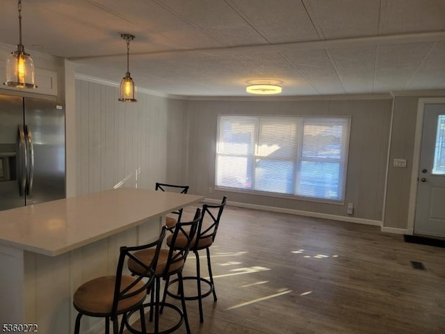 131 Douglas Dr, Jackson Twp, NJ 08527 - kitchen featuring crown molding, dark wood-style flooring, healthy amount of natural light, a kitchen bar, and a kitchen island
