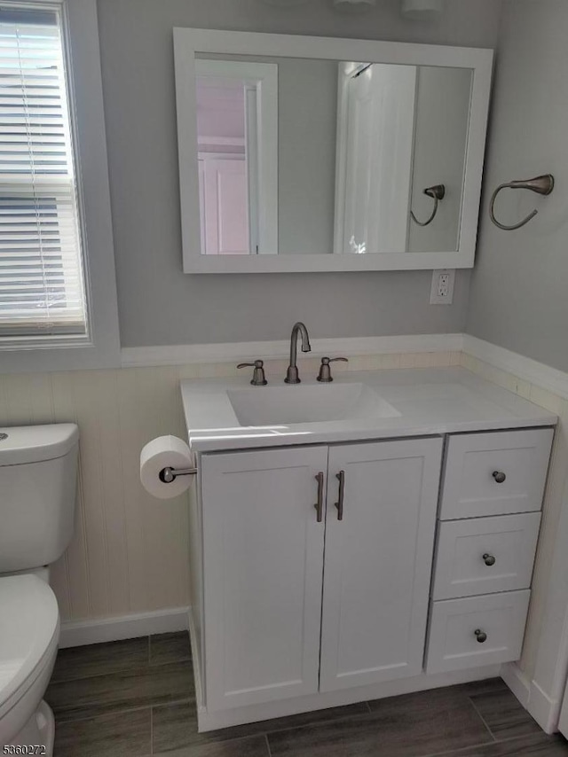131 Douglas Dr, Jackson Twp, NJ 08527 - bathroom with toilet, vanity, wood finished floors, and a wainscoted wall