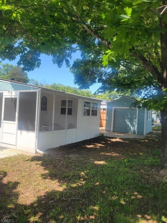 131 Douglas Dr, Jackson Twp, NJ 08527 - back of house with a sunroom and an outbuilding