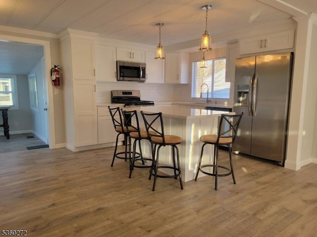 131 Douglas Dr, Jackson Twp, NJ 08527 - kitchen featuring appliances with stainless steel finishes, white cabinetry, a center island, and crown molding