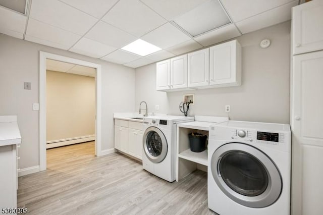 66 Fernwood Rd, Summit City, NJ 07901 - washroom featuring a baseboard radiator, washing machine and dryer, light wood finished floors, and cabinet space