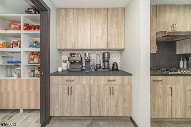 116 Wolfs Corner Rd, Green Twp, NJ 07860 - bar area featuring under cabinet range hood, decorative backsplash, and stainless steel gas stovetop