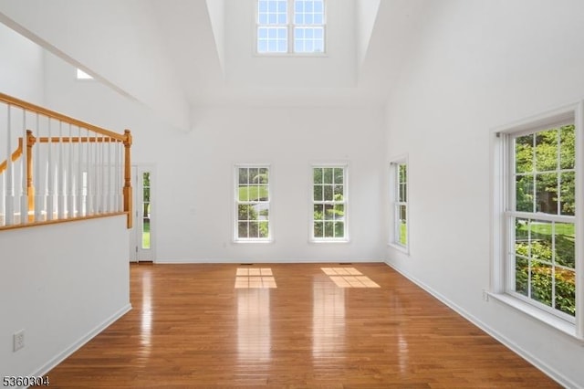 3 Spyglass Hl, Fredon Twp, NJ 07860 - unfurnished living room with high vaulted ceiling, healthy amount of natural light, wood finished floors, and baseboards