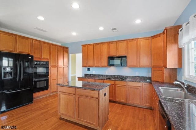 3 Spyglass Hl, Fredon Twp, NJ 07860 - kitchen with black appliances, a sink, light wood-style flooring, a kitchen island, and dark stone countertops
