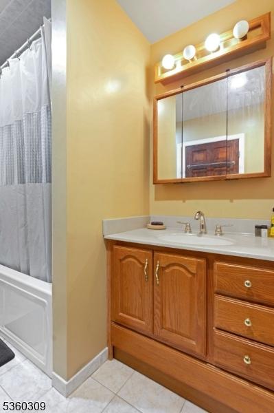 36 William St, West Orange Twp, NJ 07052 - bathroom featuring vanity, tile patterned flooring, and baseboards