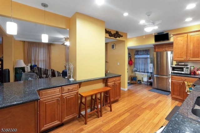36 William St, West Orange Twp, NJ 07052 - kitchen featuring appliances with stainless steel finishes, a ceiling fan, a breakfast bar area, light wood-style flooring, and recessed lighting