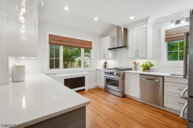 51 S Pierson Rd, Maplewood Twp, NJ 07040 - kitchen with stainless steel appliances, wall chimney range hood, radiator heating unit, light countertops, and recessed lighting
