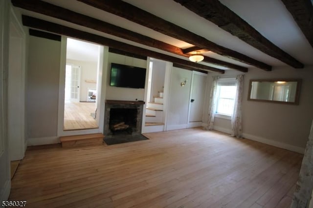 89 Leffler Hill Rd, Raritan Twp, NJ 08822 - unfurnished living room with beam ceiling, light wood-type flooring, and a fireplace with flush hearth