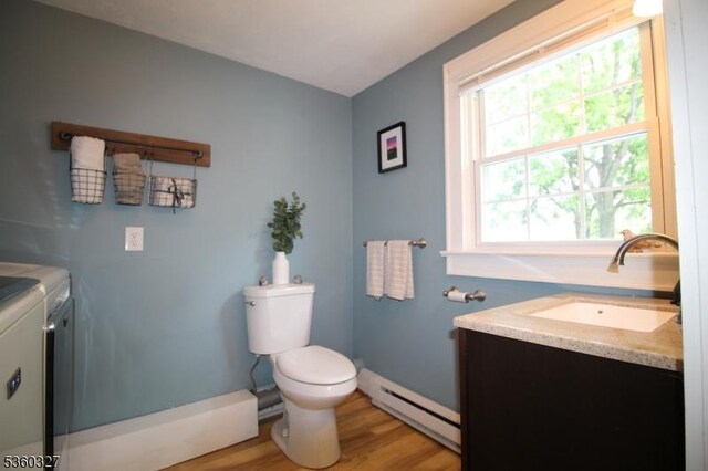 89 Leffler Hill Rd, Raritan Twp, NJ 08822 - half bath featuring baseboard heating, washing machine and clothes dryer, vanity, and wood finished floors