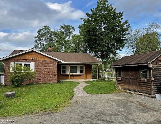 111 Lake Dr, Byram Twp, NJ 07874 - view of front of house with a porch, a front lawn, a chimney, and an outdoor structure