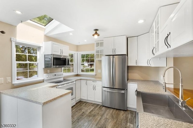 111 Lake Dr, Byram Twp, NJ 07874 - kitchen with appliances with stainless steel finishes, a sink, wood finished floors, glass insert cabinets, and white cabinets