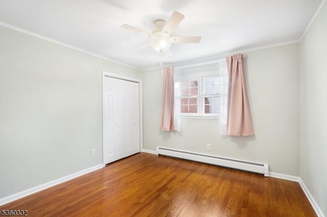 111 Lake Dr, Byram Twp, NJ 07874 - empty room featuring baseboard heating, ornamental molding, wood finished floors, baseboards, and a ceiling fan