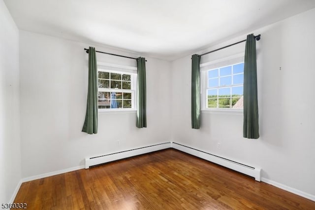 111 Lake Dr, Byram Twp, NJ 07874 - spare room featuring wood finished floors, healthy amount of natural light, baseboards, and a baseboard radiator