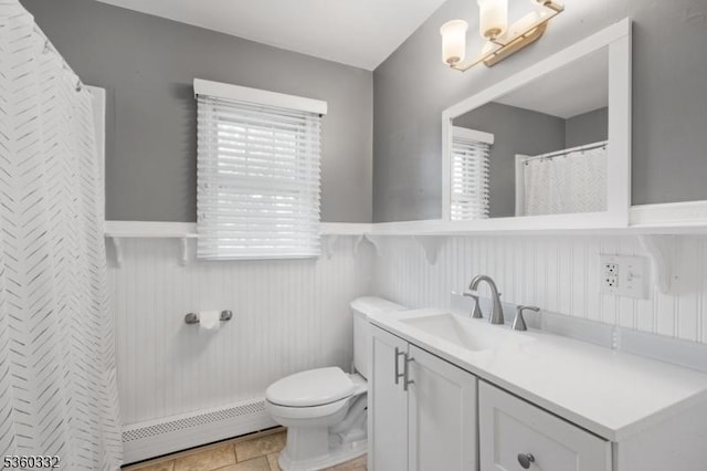 111 Lake Dr, Byram Twp, NJ 07874 - bathroom featuring a baseboard heating unit, wainscoting, toilet, vanity, and plenty of natural light