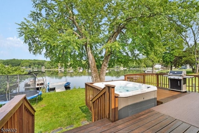 111 Lake Dr, Byram Twp, NJ 07874 - deck with a hot tub, a trampoline, a water view, a lawn, and grilling area