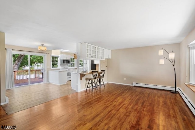 111 Lake Dr, Byram Twp, NJ 07874 - living room with baseboard heating, wood finished floors, and baseboards