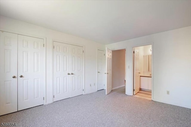 60 Mews Ln Unit 60, South Orange Village Twp, NJ 07079 - unfurnished bedroom featuring two closets, light colored carpet, and connected bathroom