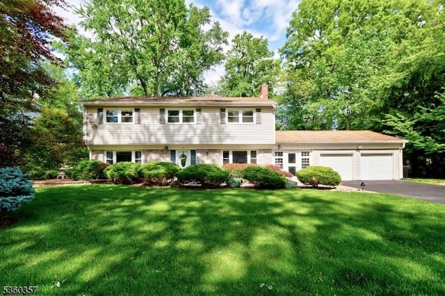 17 Druid Hill Dr, Parsippany-Troy Hills Twp, NJ 07054 - colonial inspired home featuring a chimney, a garage, asphalt driveway, and a front yard