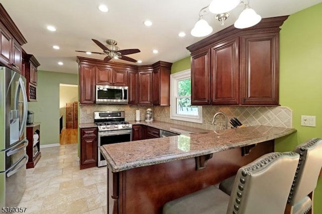 17 Druid Hill Dr, Parsippany-Troy Hills Twp, NJ 07054 - kitchen featuring appliances with stainless steel finishes, a peninsula, a ceiling fan, backsplash, and recessed lighting