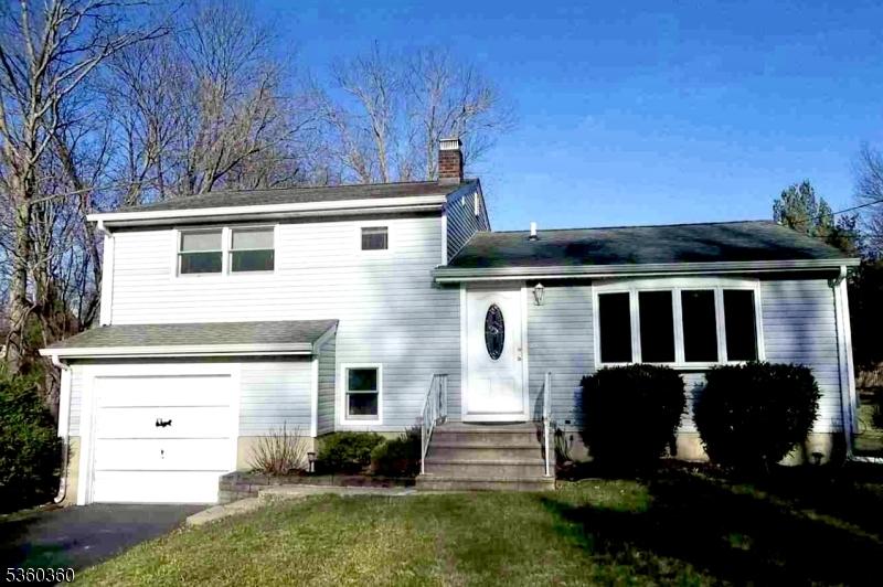 66 Garden Ave, Franklin Twp, NJ 08823 - view of front of property featuring a chimney, an attached garage, driveway, and a front yard