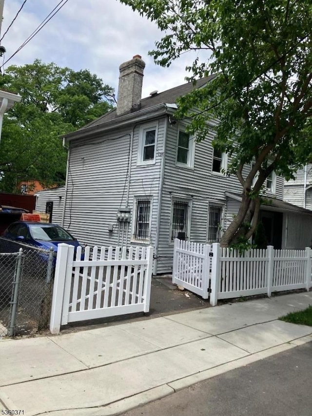53 Glenwood Ave, City Of Orange Twp, NJ 07050 - view of home's exterior with a chimney and a fenced front yard