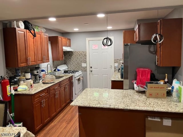 53 Glenwood Ave, City Of Orange Twp, NJ 07050 - kitchen featuring white range with gas cooktop, a sink, light wood-type flooring, under cabinet range hood, and backsplash