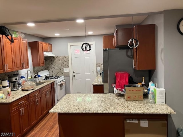 53 Glenwood Ave, City Of Orange Twp, NJ 07050 - kitchen with white range with gas stovetop, a sink, light wood-style flooring, backsplash, and under cabinet range hood