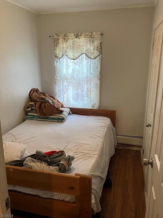 53 Glenwood Ave, City Of Orange Twp, NJ 07050 - bedroom featuring baseboard heating, wood finished floors, and ornamental molding